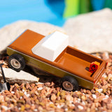 Close up of the Candylab handmade wooden sierra longhorn pickup truck toy on some small brown stones