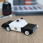 Candylab childrens police cruiser collectable toy on a wooden desk