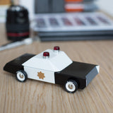 Candylab childrens police cruiser collectable toy on a wooden desk