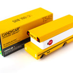Candylab wooden bus toy on a rubber road set next to some pink and grey toy cars