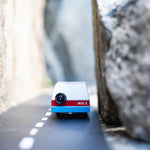Candylab blue wooden mule car toy driving on a rubber road between two stones