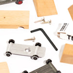 Pieces of the candylab childrens wooden car building kit scattered on a white background