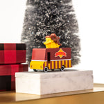 Candylab wooden candyvan waffle truck on a pile of presents in front of a Christmas tree