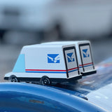 2 Candylab collectable miniature post van toys on a blue postbox