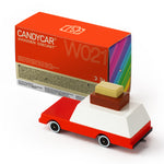 Candylab kids handmade wooden luggage wagon toy car on a white background next to its cardboard box