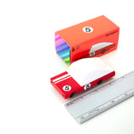 Candylab solid wooden red race car toy on a white background next to its box and a metal ruler