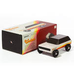 Candylab handmade wooden Wanderer SUV toy on a white background next to its box