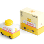 Picture of the Citron Candylab Candyvan with its box. It is a 1960s style yellow and white van with a yellow Lemon Macaron on the roof.