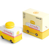 Picture of the Citron Candylab Candyvan with its box. It is a 1960s style yellow and white van with a yellow Lemon Macaron on the roof.