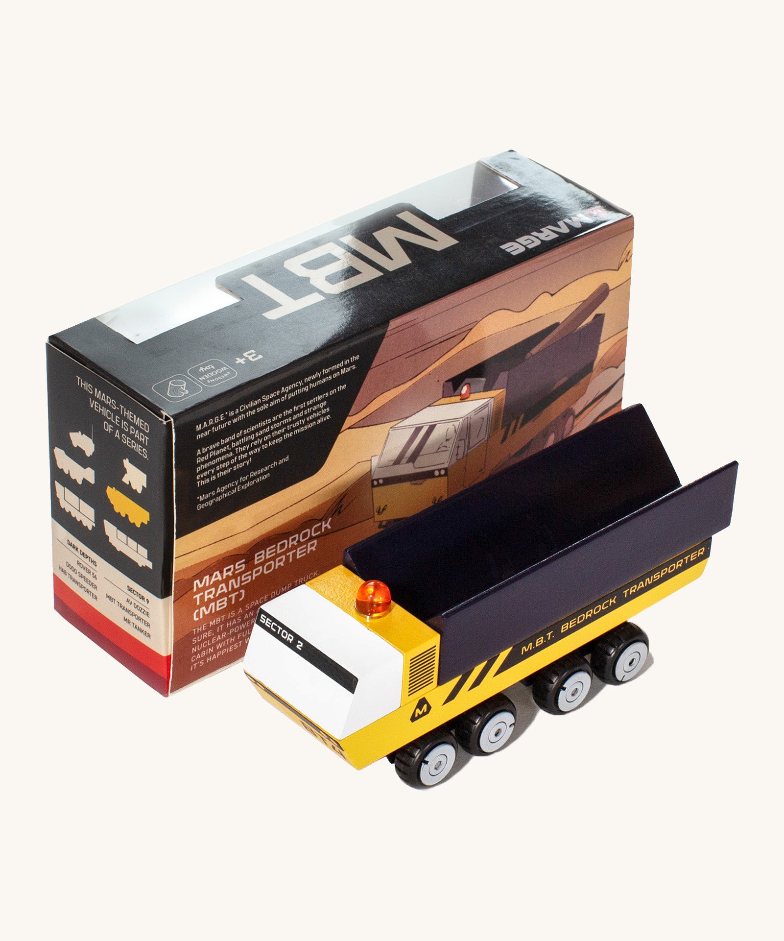 CandyLab yellow and black MBT Transporter vehicle front detail view next to the original cardboard packaging.
