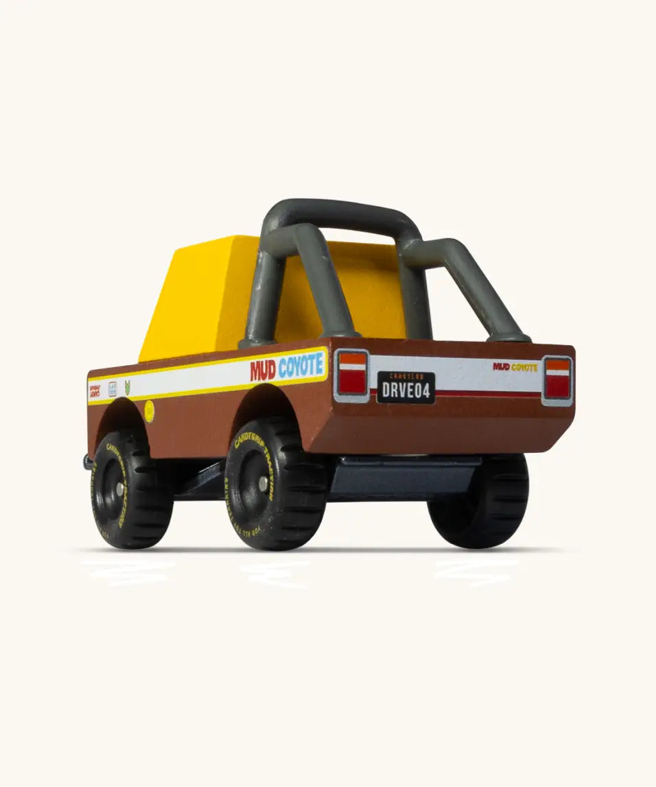 Back of Candylab mud coyote truck. A wooden diecast toy car showing the roll cage and retro decals