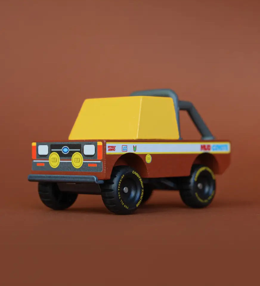 Front of Candylab mud coyote toy truck showing yellow window, roll cage and retro decals