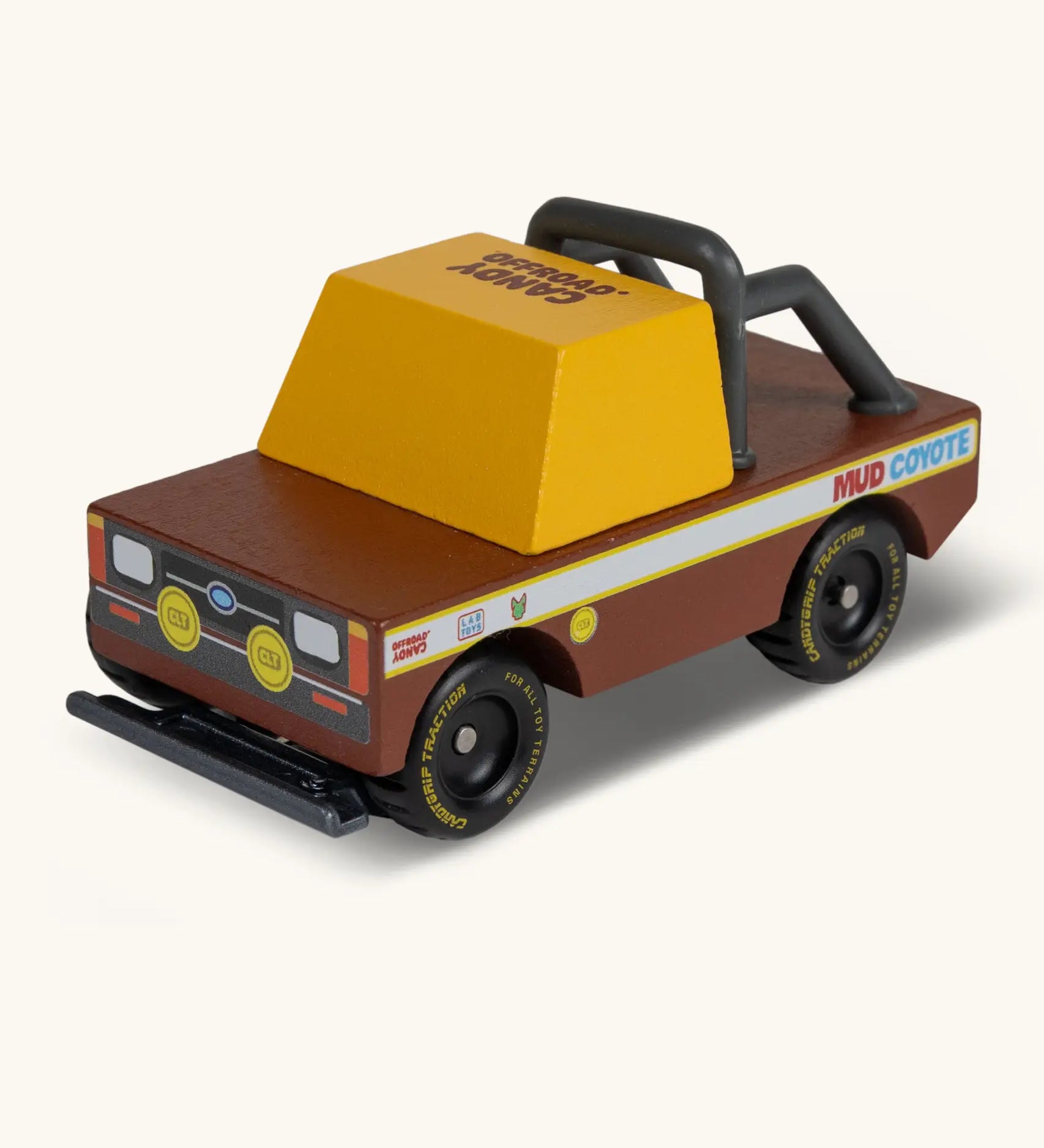 Candylab mud coyote truck. A wooden diecast toy car with a brown body, yellow window, roll cage and retro decals