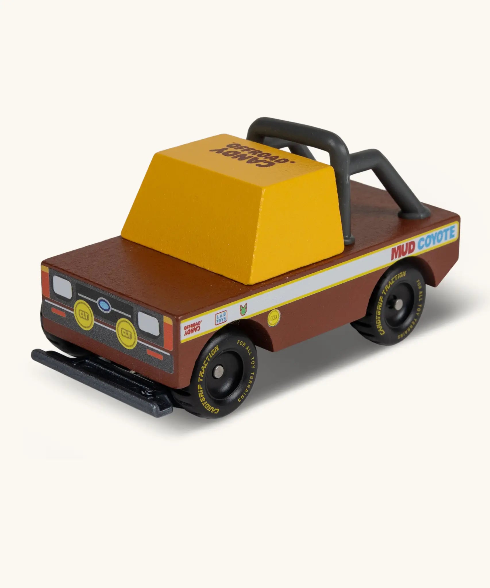 Candylab mud coyote truck. A wooden diecast toy car with a brown body, yellow window, roll cage and retro decals