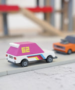 Candylab wooden diecast pink 62 racer toy car on a play road with another car in the background
