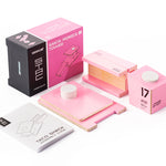 Pieces of the Candylab beach tower diecast model on a white background next to the pink box
