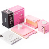Pieces of the Candylab beach tower diecast model on a white background next to the pink box