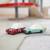 Candylab wooden diecast tora drift teal toy car next to a hachigo red toy car on a play road