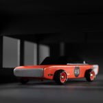 Close up of the Candylab red seagull race car toy on a black and grey background