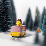 Close up of the Candylab collectable waffle truck toy on a toy road surrounded by miniature trees and snow