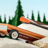 Close up of the Candylab eco-friendly wooden big sur car toy on some large rocks
