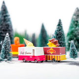Candylab wooden ice cream and waffle truck toys on a toy road next to some miniature trees and snow