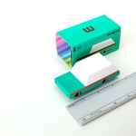 Candylab kids teal wagon car toy on a white background next to its cardboard box and metal ruler