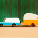 Candylab kids wooden blue mule car toy with the rosebud toy trailer attached on an orange and green background