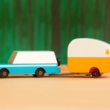 Candylab kids wooden blue mule car toy with the rosebud toy trailer attached on an orange and green background