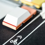 Close up of the back of a Candylab wooden dart toy car on a rubber road