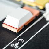 Close up of the back of a Candylab wooden dart toy car on a rubber road