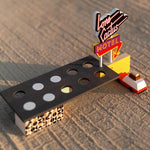 Close up of the Candylab childrens wooden motel model on a sandy background