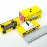 Candylab childrens wooden toy taxi on a white background next to a metal ruler and its yellow box