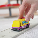 Adult hand holding a Candylab wooden diecast yellow speed vandal toy van showing scale