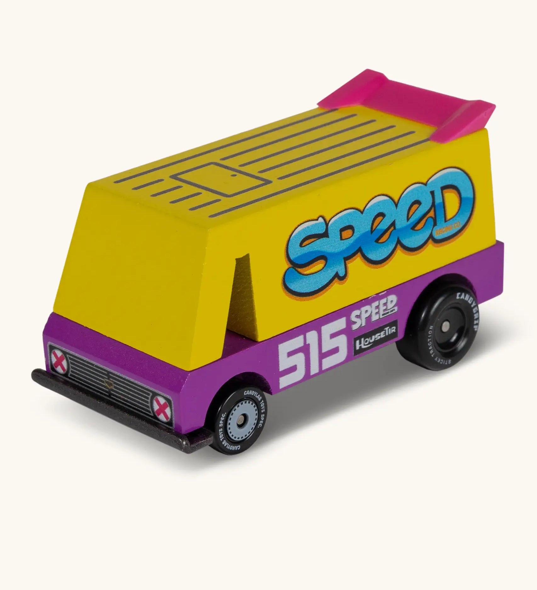 Candylab speed vandal van. A wooden diecast toy car with a yellow and purple body, pink spoiler and retro decals