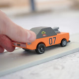Adult hand pushing the Candylab wooden diecast stormduker orange muscle toy car showing scale
