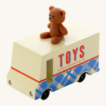CandyLab cream and blue CandyVan with a brown teddy bear on the roof with Toys text logo in red on the side - front view.