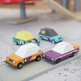 4 Candylab Tokyo heat toon cars on a play road with a parking garage in the background.