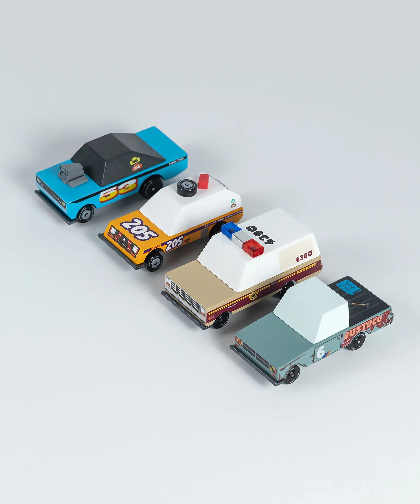 4 wooden diecast sturdy Candylab toon cars from the rust patrol set lined up on an angle