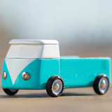 Close up of the candylab handmade wooden blue beach campervan toy on a beige background