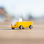 Close up of a Candylab eco-friendly wooden campervan toy on a beige background