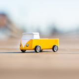 Close up of a Candylab eco-friendly wooden campervan toy on a beige background