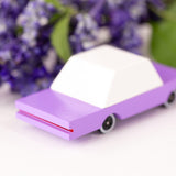 Candylab childrens wooden bberry candycar on a white background next to some purple flowers