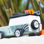 Back of the Candylab childrens wooden zebra drifter suv toy on some sand next to its spare tyre