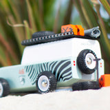 Back of the Candylab childrens wooden zebra drifter suv toy on some sand next to its spare tyre