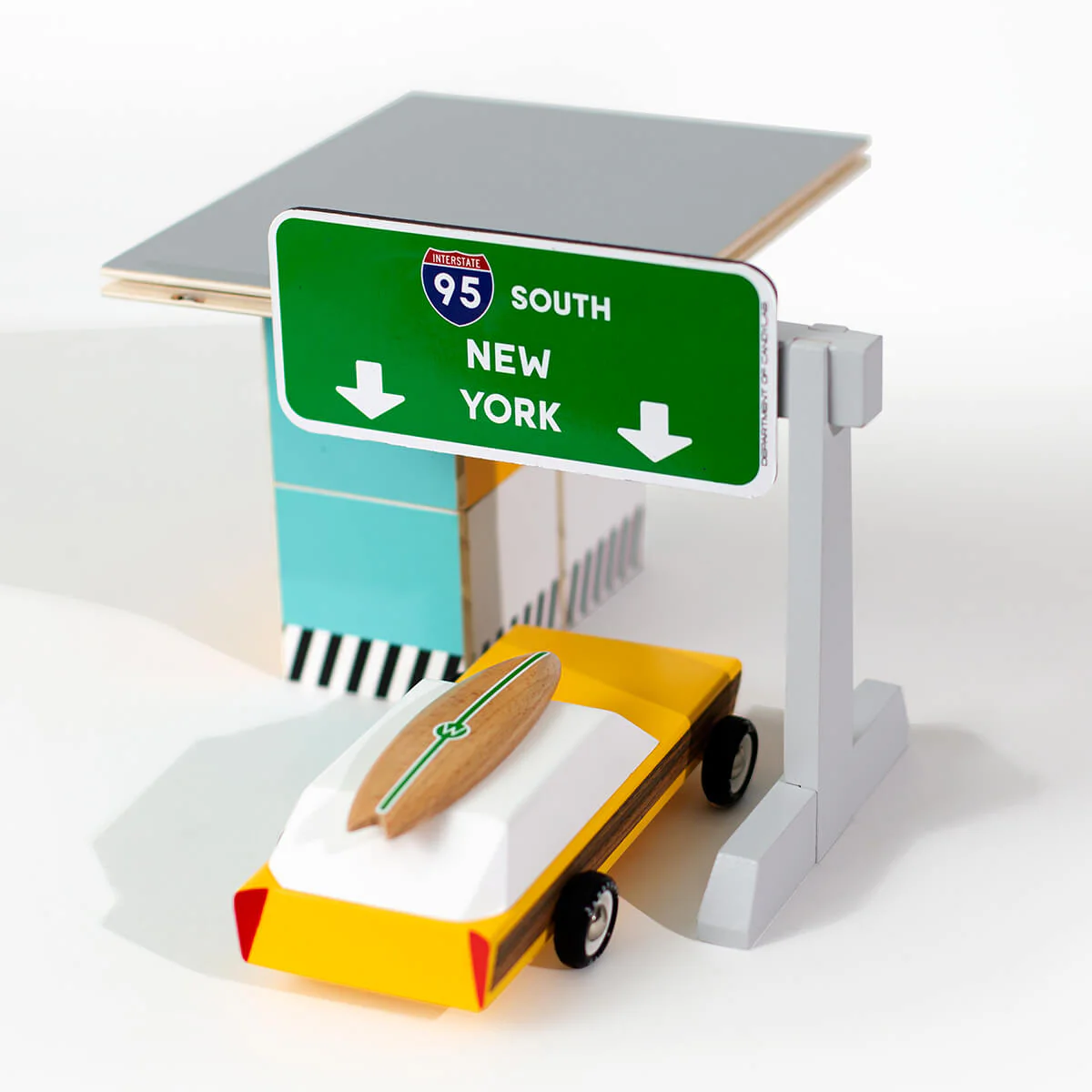 The Candylab toy car wooden toll booth toy, with a candylab car driving through.