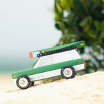 Picture of the magnetic wooden canoe boat toy attached to a Candylab Big Sur toy car.