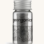 Charcoal Georganics floss on a cream backround