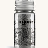 Charcoal Georganics floss on a cream backround