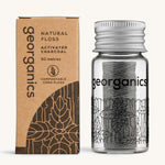 Charcoal Georganics floss with the cardboard box on a cream backround